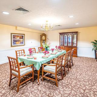 A well-decorated dining room with a table set for a meal.