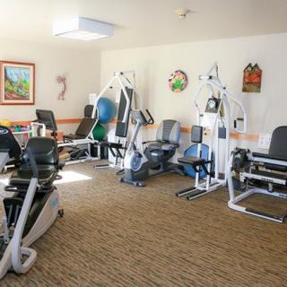 A well-equipped indoor gym with various exercise machines.
