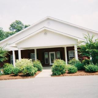 A well-landscaped building entrance with a covered walkway.