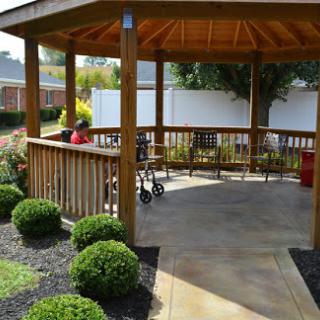 A serene gazebo nestled in a beautifully landscaped garden, perfect for relaxation.