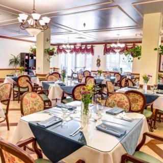 An elegant restaurant dining room with beautifully set tables and classic decor.