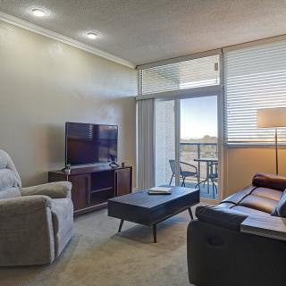 A cozy living room with modern furniture and a view of the balcony.