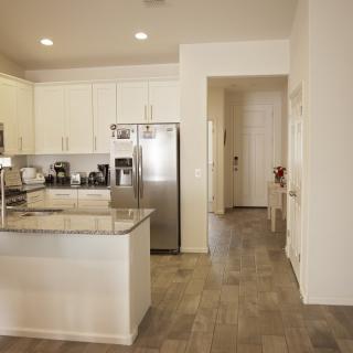 A modern kitchen interior with stainless steel appliances and white cabinetry.