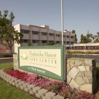 A healthcare facility with a prominently displayed sign and well-maintained landscaping.