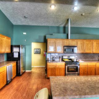 A modern kitchen featuring wooden cabinets, sleek appliances, and an open layout perfect for entertaining.