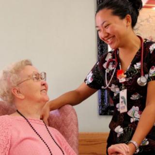 A nurse providing compassionate care to an elderly woman.