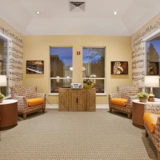 A cozy living room with two armchairs, side tables, and warm lighting.