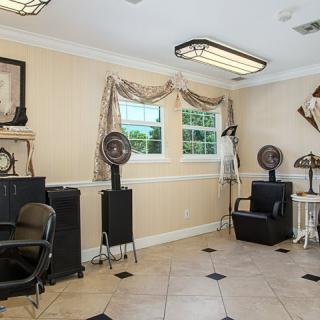 A cozy salon interior with chairs and hairdryers, featuring elegant decor and natural lighting.