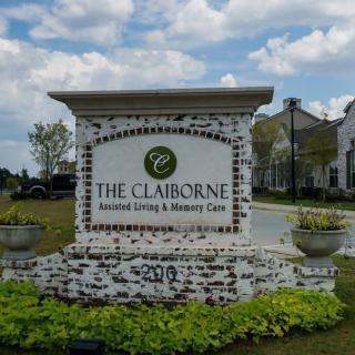 Outdoor sign for The Claiborne Assisted Living & Memory Care facility.