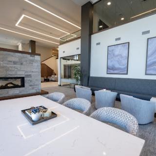 A sleek and modern living room featuring a stylish fireplace, elegant furniture, and contemporary artwork.