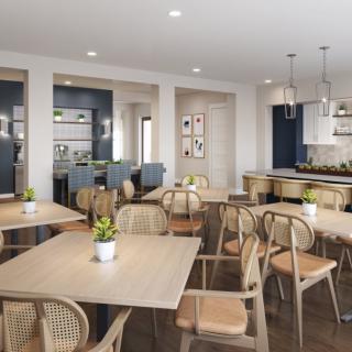 A modern dining area featuring wooden tables, chairs, pendant lighting, and decorative plants.
