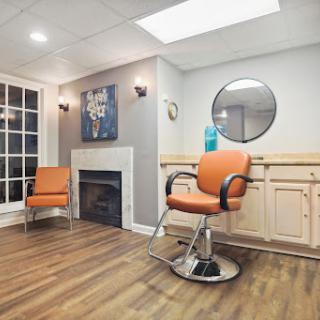 A stylish and modern barber shop featuring comfortable seating and a welcoming atmosphere.
