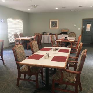 A quiet dining area with neatly arranged tables and chairs.