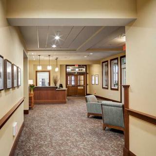 A well-lit office lobby with seating and a reception desk.