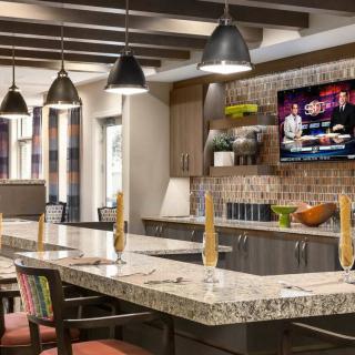 A modern kitchen interior with a spacious countertop and stylish pendant lights.