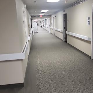 A view of a clean and well-lit hospital hallway.