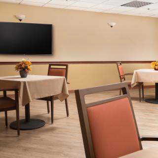 An empty restaurant dining area with neatly arranged tables and chairs.