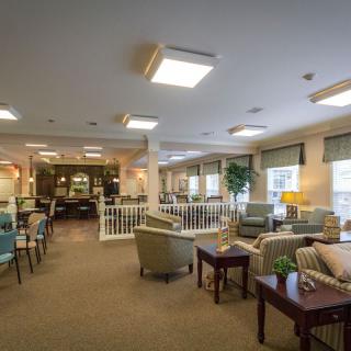 A cozy communal living area with comfortable seating and soft lighting.
