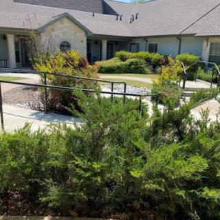 A well-maintained residential building surrounded by greenery.