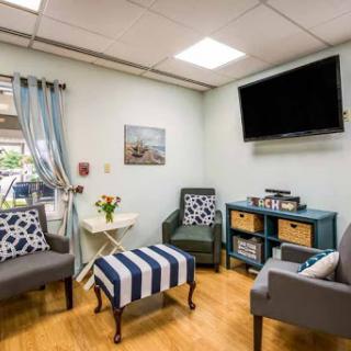 A cozy and modern waiting room with comfortable seating and decorative touches.