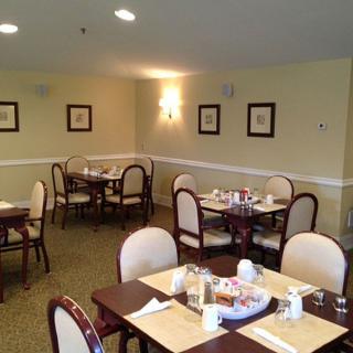 An empty dining room with neatly arranged tables and chairs.