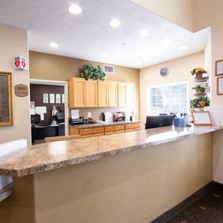 A view of a reception desk in an office setting with bright lighting.