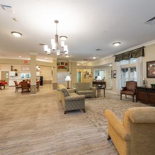 A spacious and cozy living room with comfortable seating and elegant lighting.