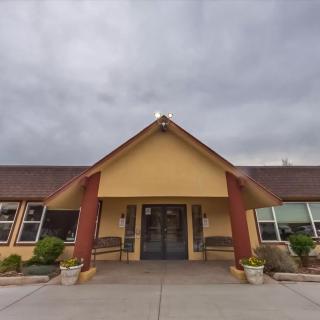 Entrance of a building under a cloudy sky.