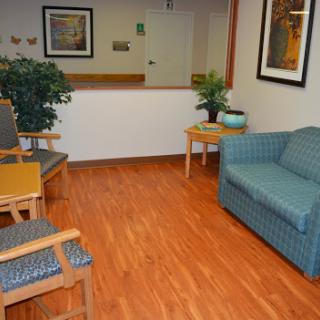 A cozy waiting area featuring comfortable seating and decorative elements.