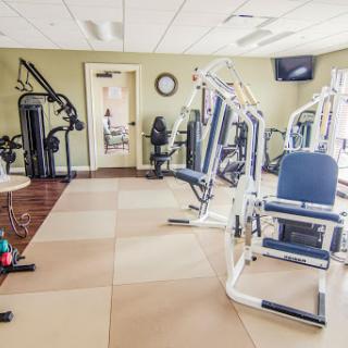 A well-equipped gym featuring various exercise machines for strength training.