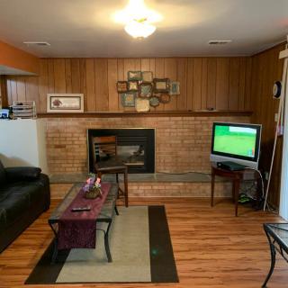Cozy living room with a fireplace, television, and comfortable seating.