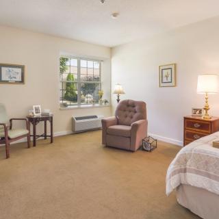 A cozy bedroom with a large armchair and soft lighting.