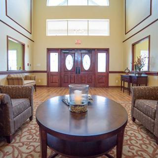 A warmly lit lobby with comfortable seating and elegant decor.
