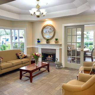 A cozy living room with comfortable seating, a fireplace, and elegant decor.
