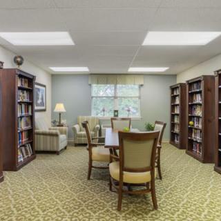 A cozy library room with bookshelves and a reading area.