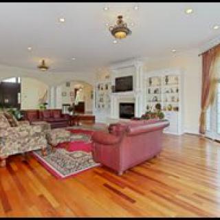 A spacious living room with elegant furnishings and hardwood floors.