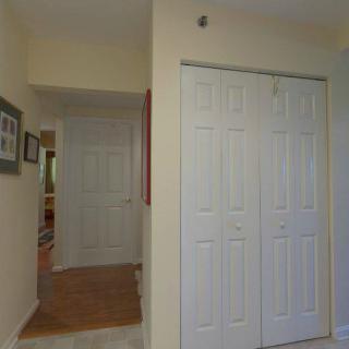 A residential hallway featuring a closet with sliding doors.