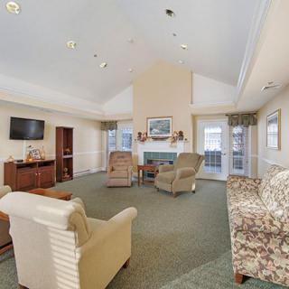 A cozy living room with comfortable seating, a fireplace, and a television.