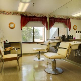 A cozy barbershop interior featuring two stylish chairs and a welcoming atmosphere.