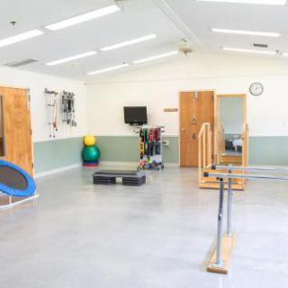 A well-equipped physical therapy room featuring various rehabilitation tools and exercise equipment.