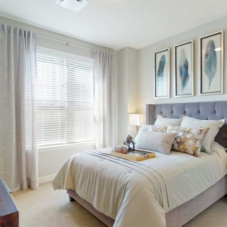 A modern and cozy bedroom with natural light and minimalist decor.