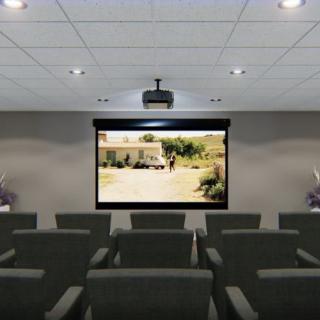 A small auditorium with rows of seating facing a projected screen.