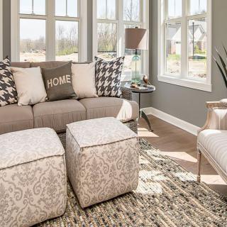 A cozy and bright living room with modern furniture and large windows.