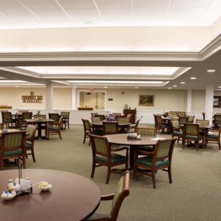 An empty dining room with arranged tables and chairs.