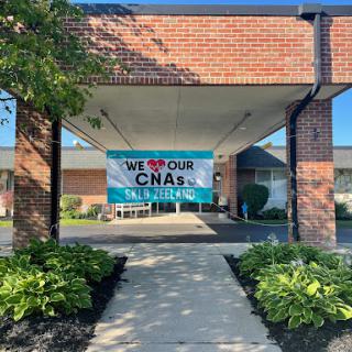 A welcoming banner displayed at the entrance of a building, emphasizing community support.