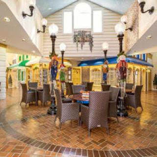 A charming indoor marketplace setting with tables and decorative lampposts.