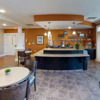 A modern kitchen with a central countertop and seating area.