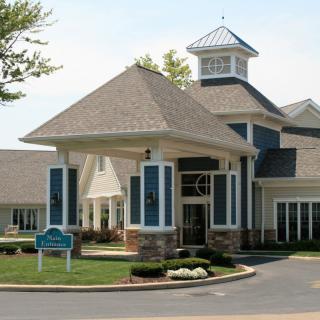 A well-designed building with a prominent entrance and landscaped surroundings.