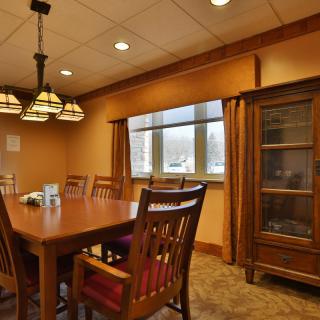 A cozy dining room with wooden furniture and a chandelier.