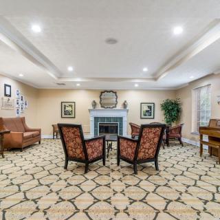 A cozy living room with comfortable seating and a central fireplace.